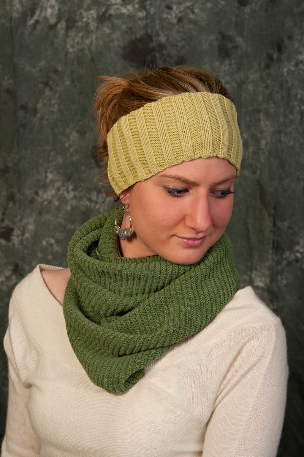 Woman wearing green knit scarf and headband