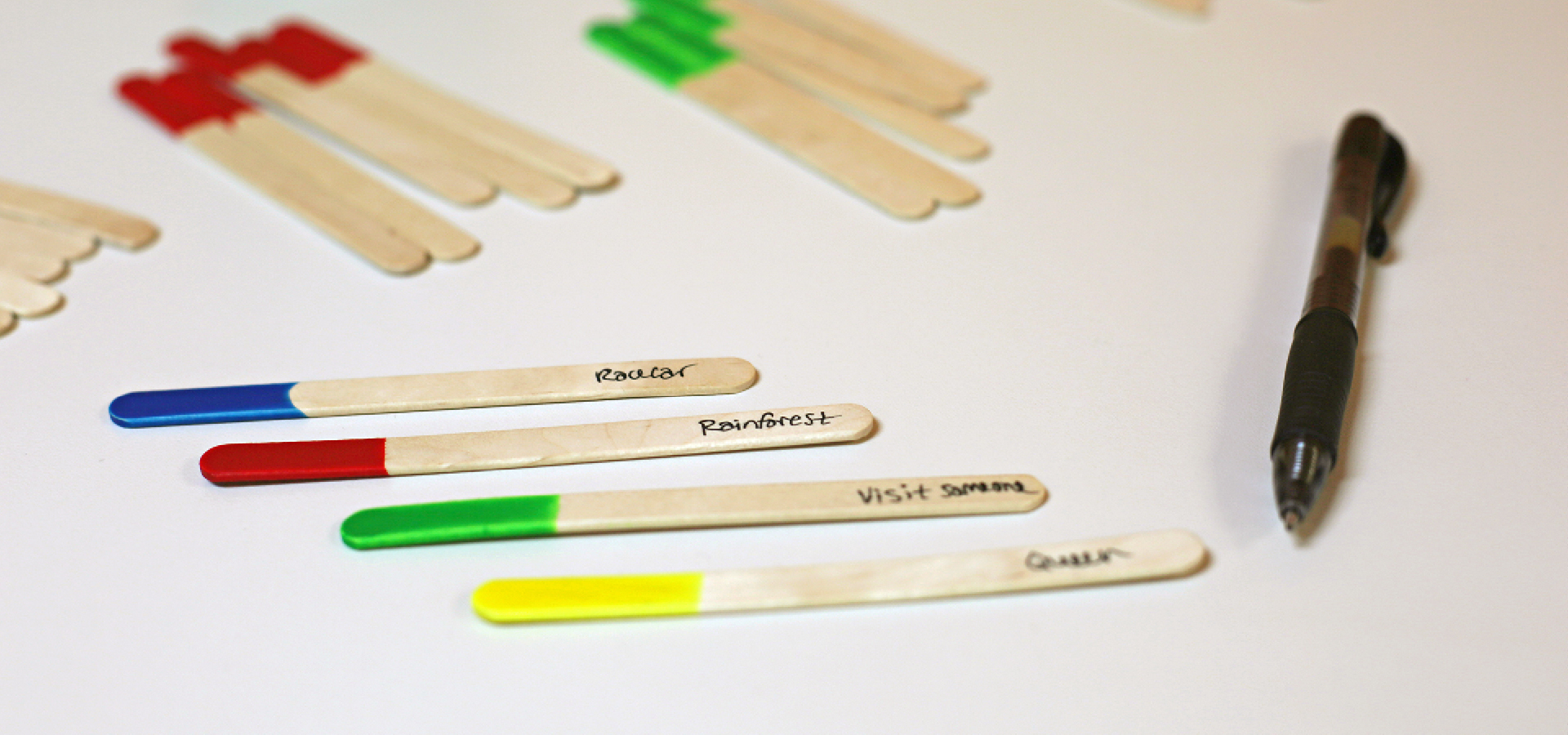 Colorful popsicle sticks with black pen