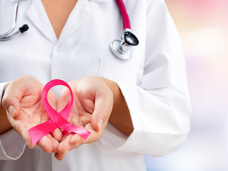 doctor holding breast cancer ribbon
