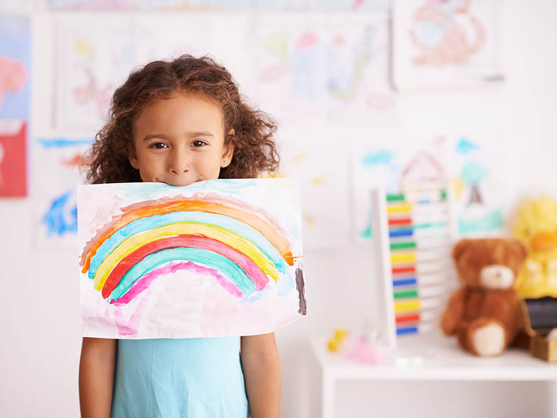 child holding artwork in mouth