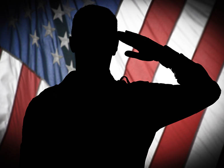 silhouette soldier saluting in front of american flag