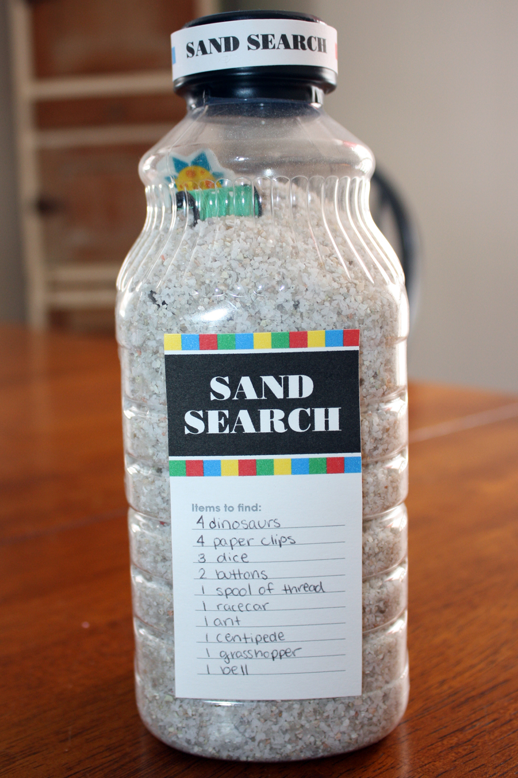 Bottle of sand filled with hidden toys
