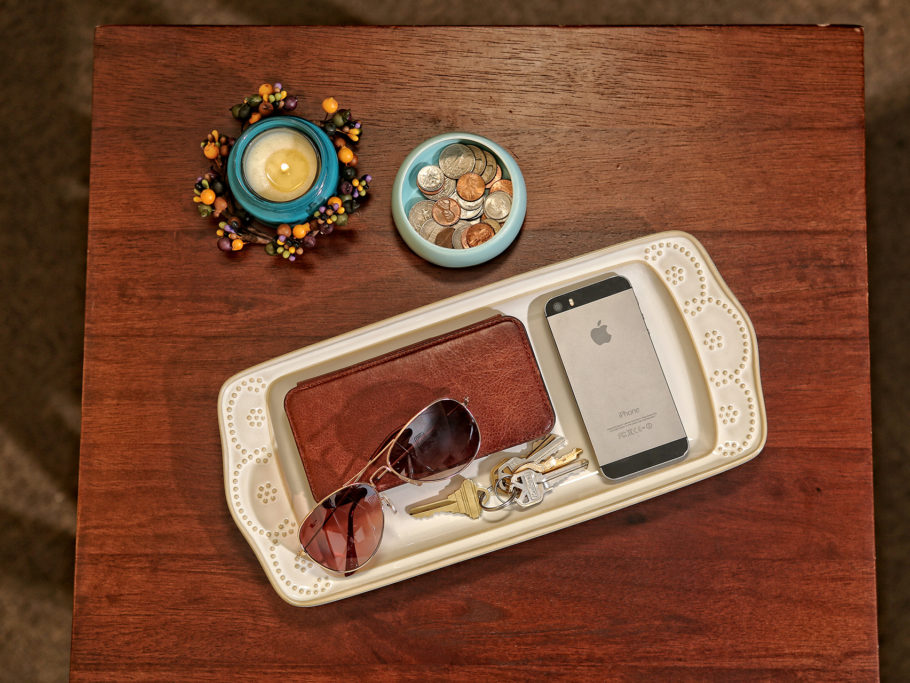 Accessories organized atop table in rectangular dish