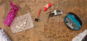 Items packed for traveling atop a map background