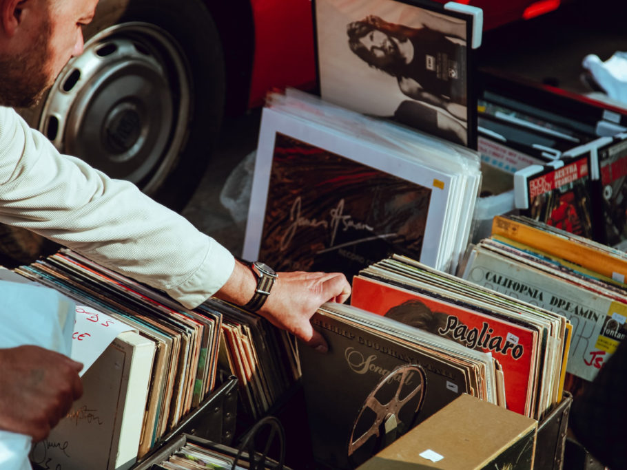 Man rifling through box of retro records