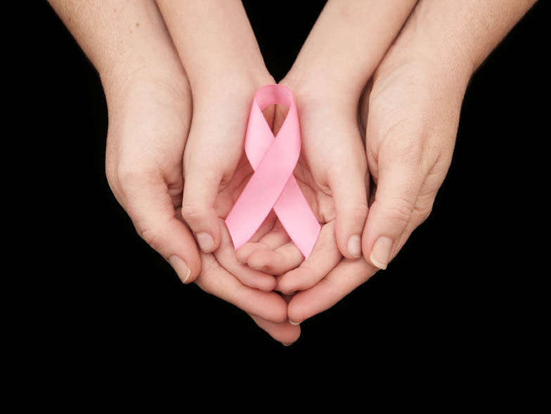 hands holding pink ribbon