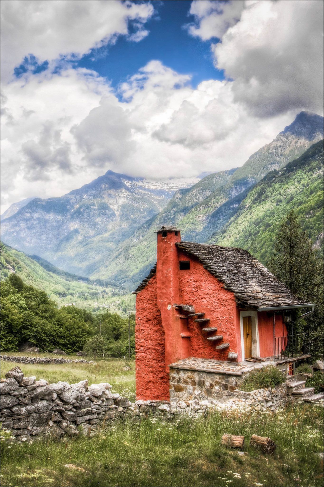 Red tiny home nesteled within mountain region