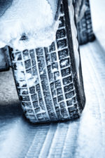 Car tires driving through snow