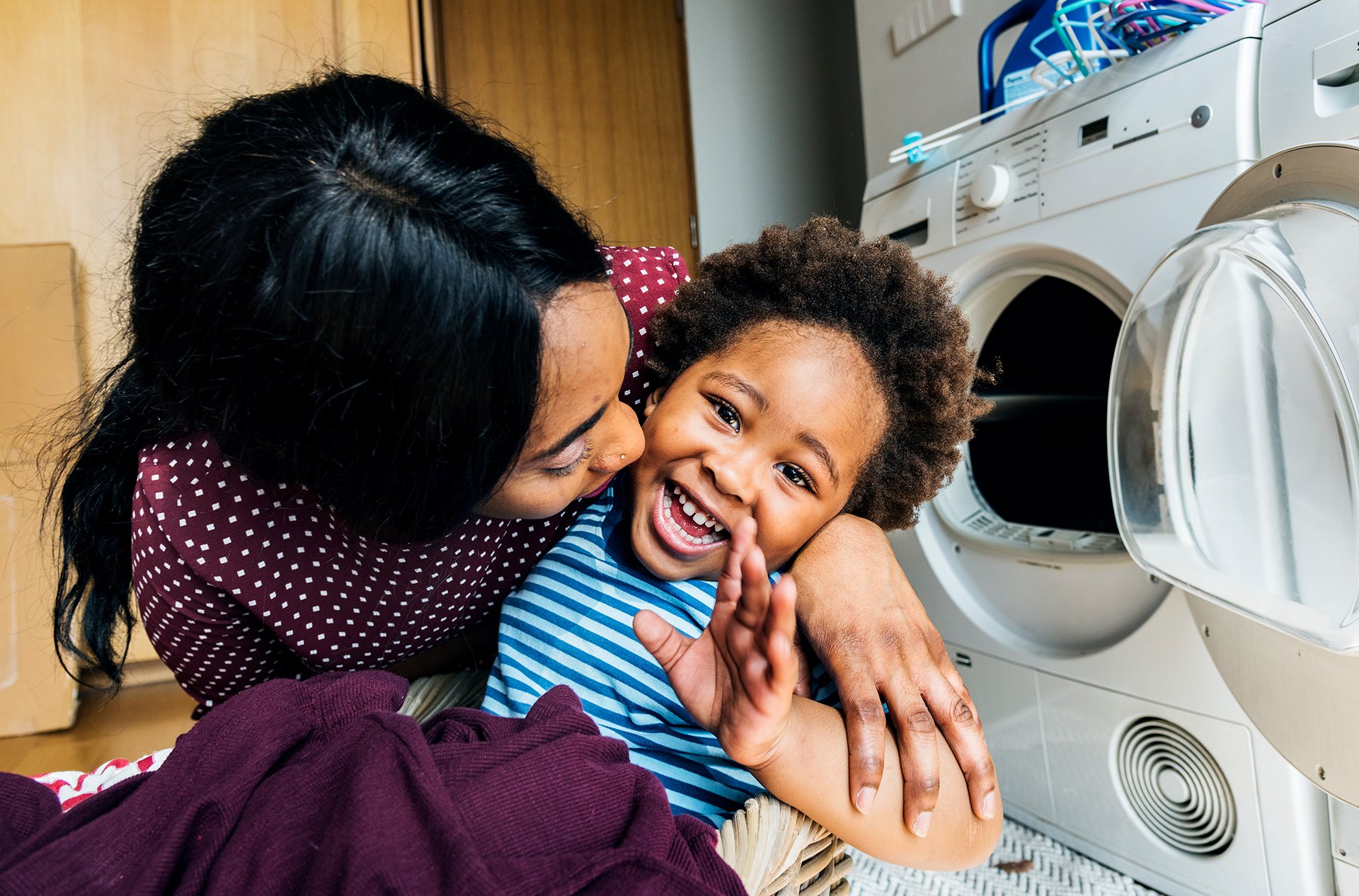 Mother and son doing laundry together