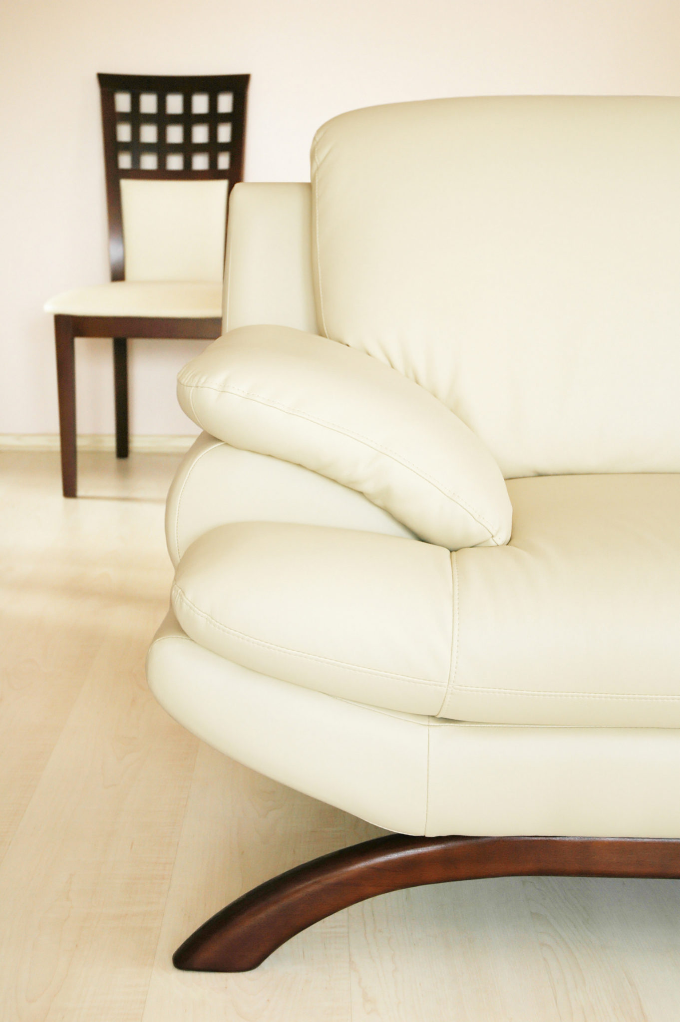Detailed view of a white leather accent chair