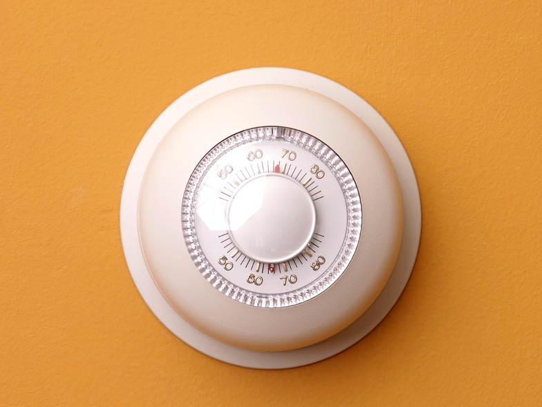 Thermostat on orange wall