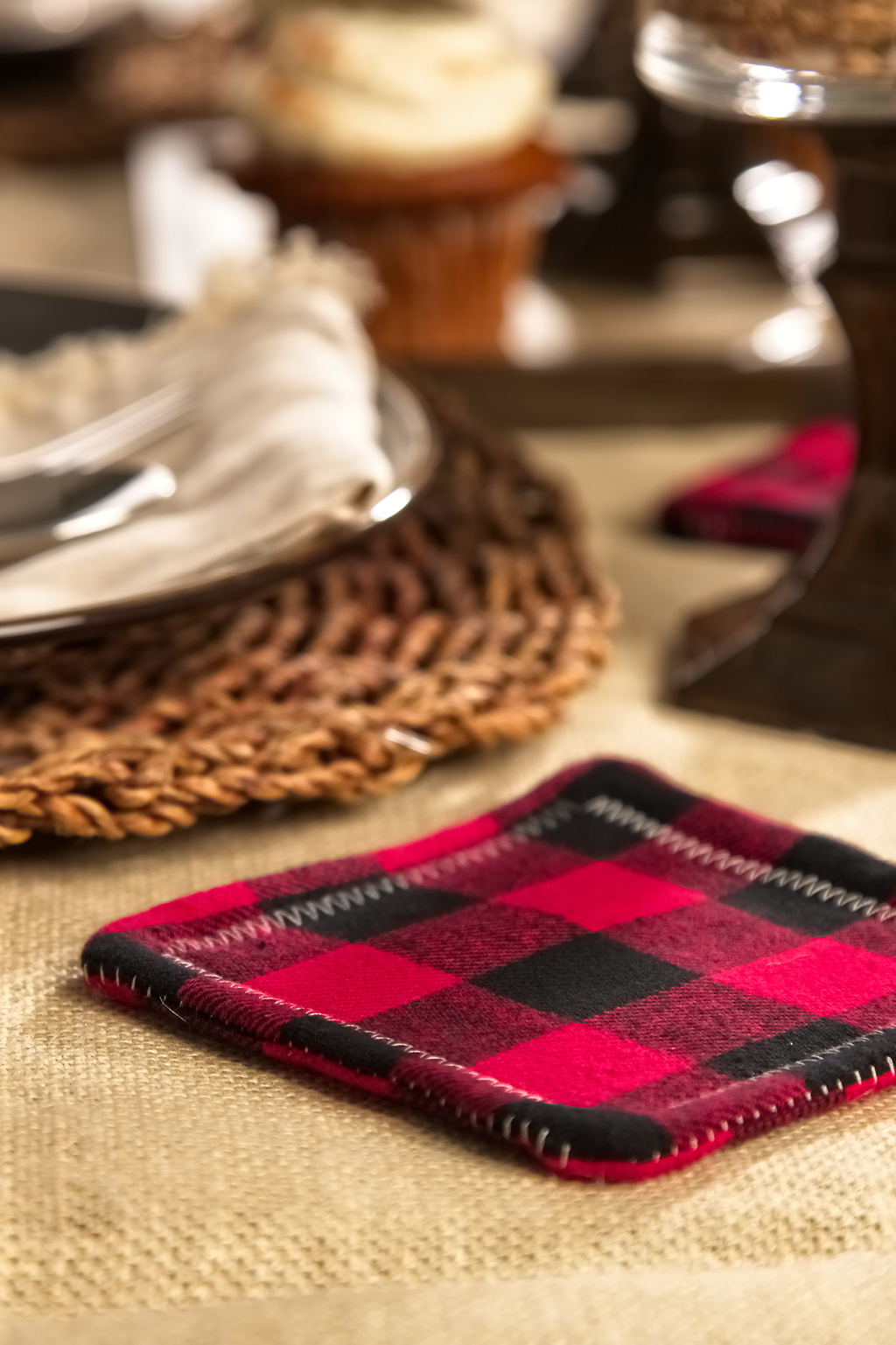 Red and black flannel coaster on table