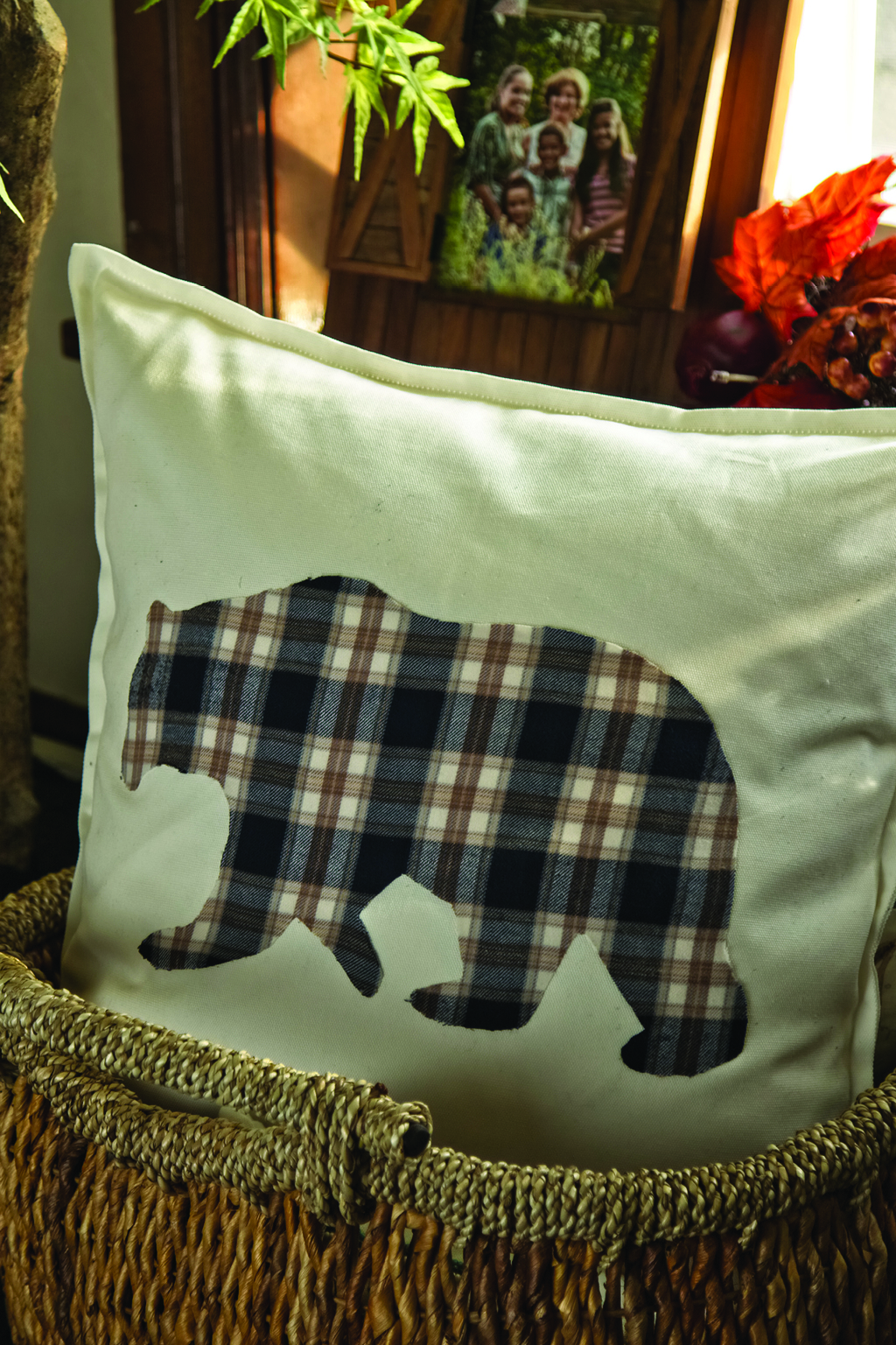 White pillow with flannel bear in center