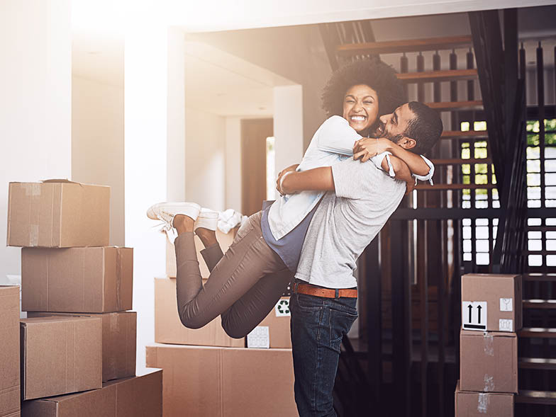 couple hugging moving boxes