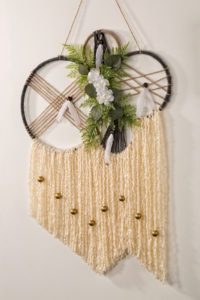 Dreamcatcher with white strings and flowers