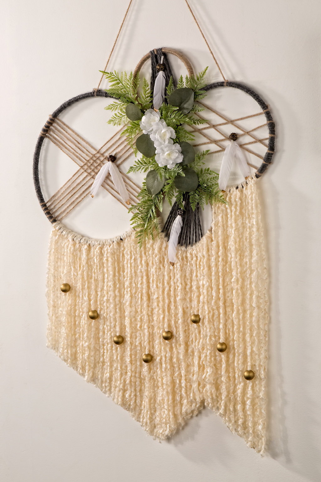 Dreamcatcher with white strings and flowers
