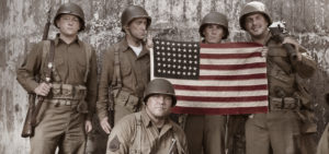 WW2 platoon holding American Flag