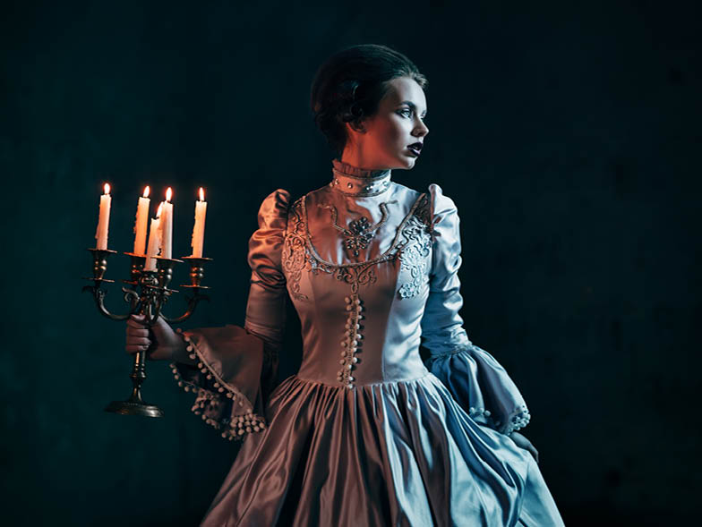 woman holding candelabra