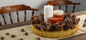 Gold pinecone wreath with candles in the center