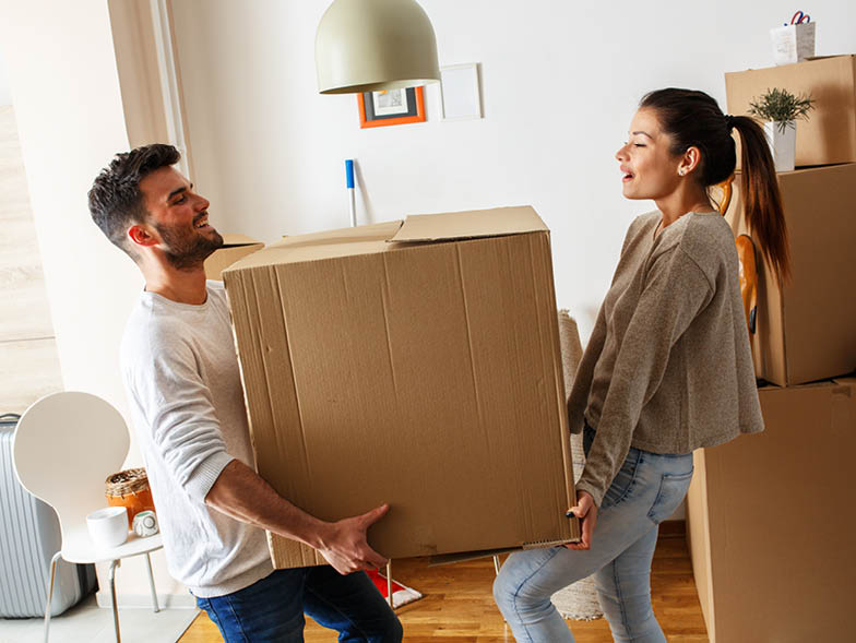 couple carrying in moving box