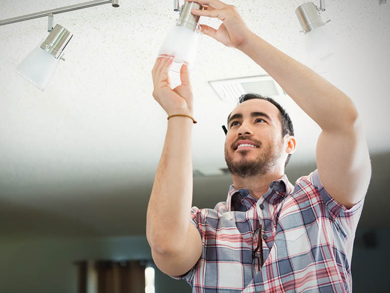 guy inserting light to fixture