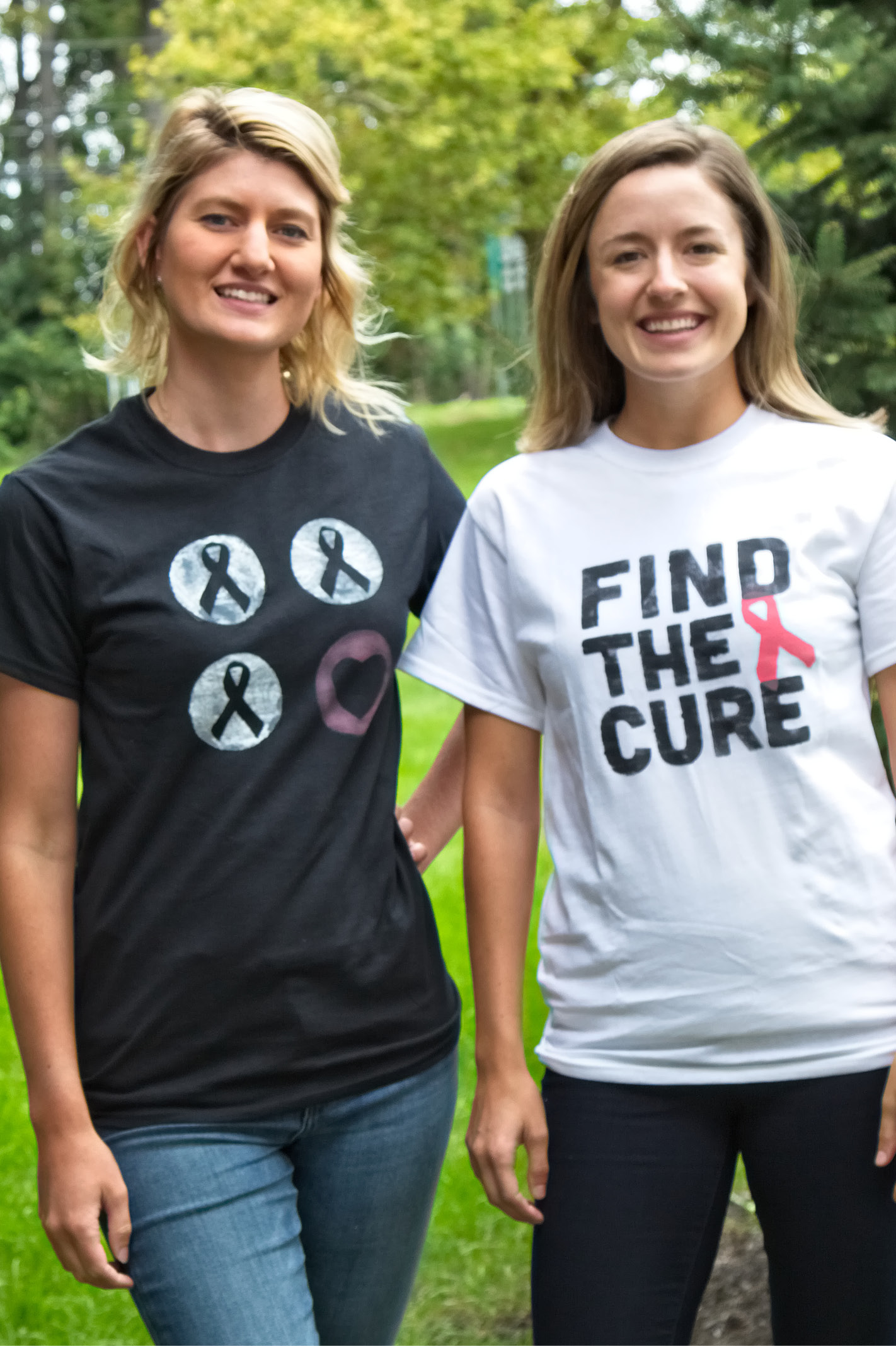 Two women posed in breast cancer awareness tees