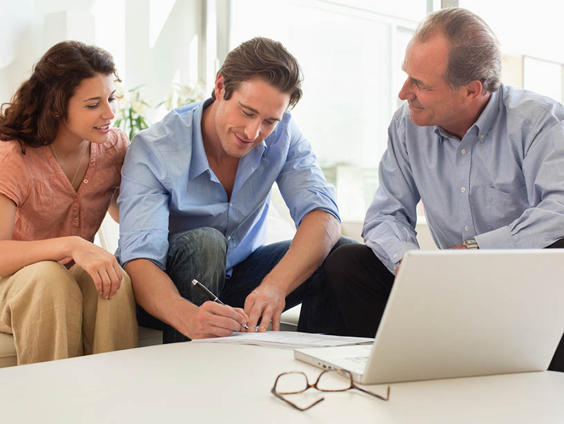 couple sitting with real estate agent