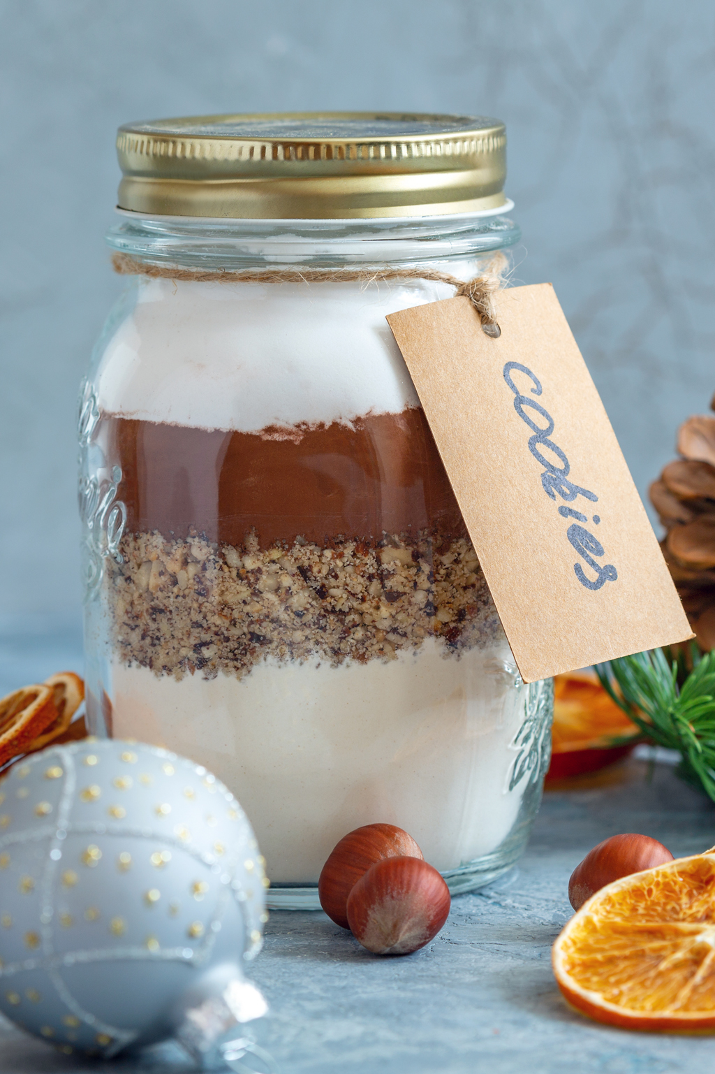 Glass jar with ingredients for baking chocolate nut cookies