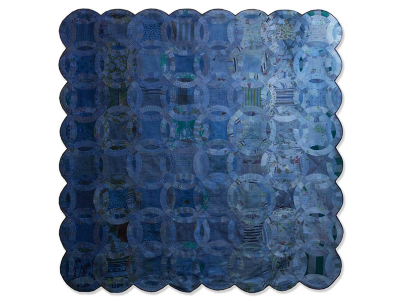 blue square quilt with scalloped edges