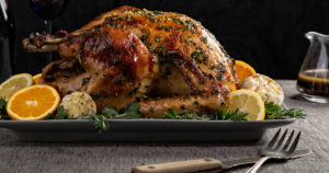 Maple garlic roast turkey on tray with gray tablecloth
