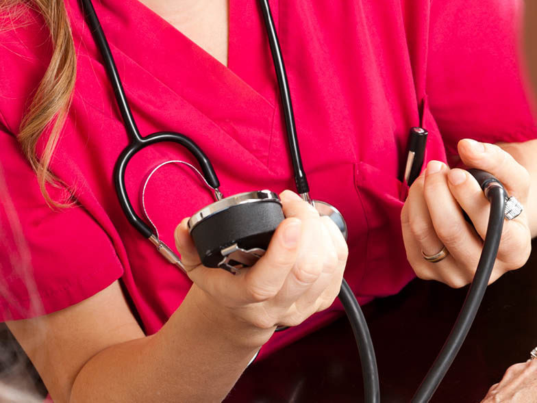 Woman holding blood pressure cuff