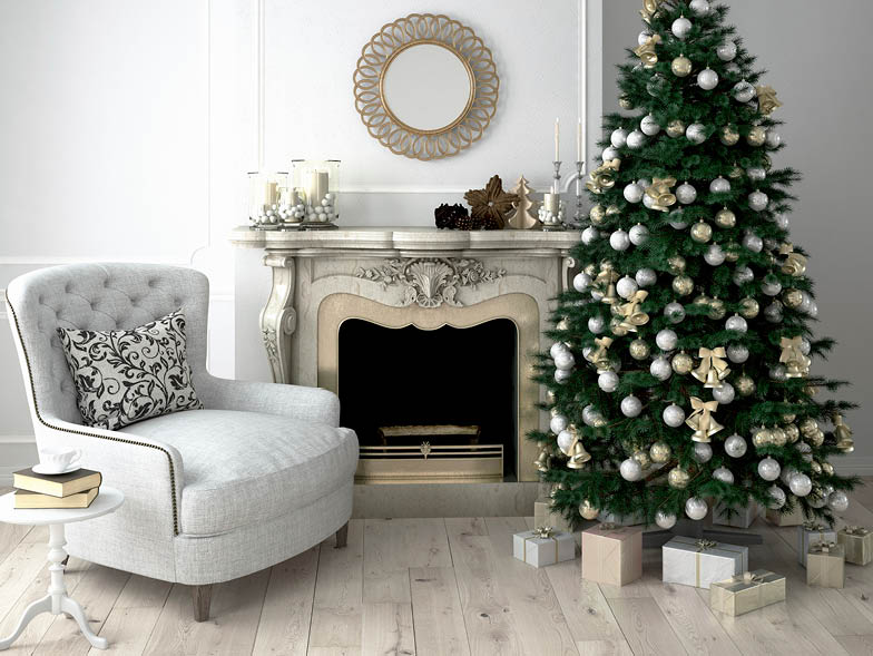 Christmas tree next to fireplace and armchair