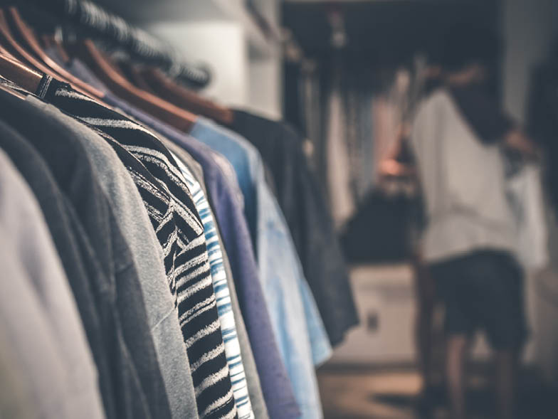 Close up of clothes hanging in a closet