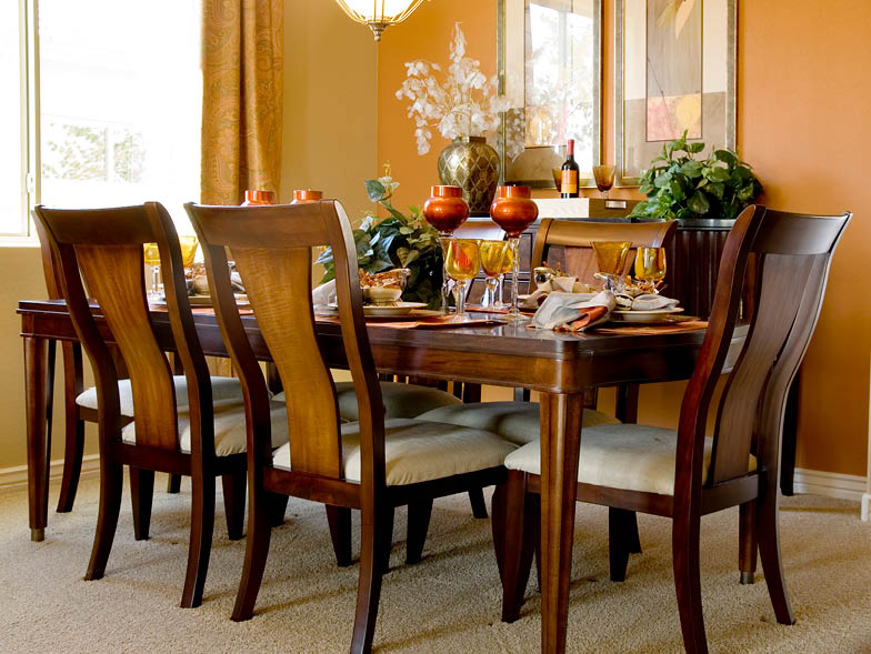 Warm colored dining room with place settings