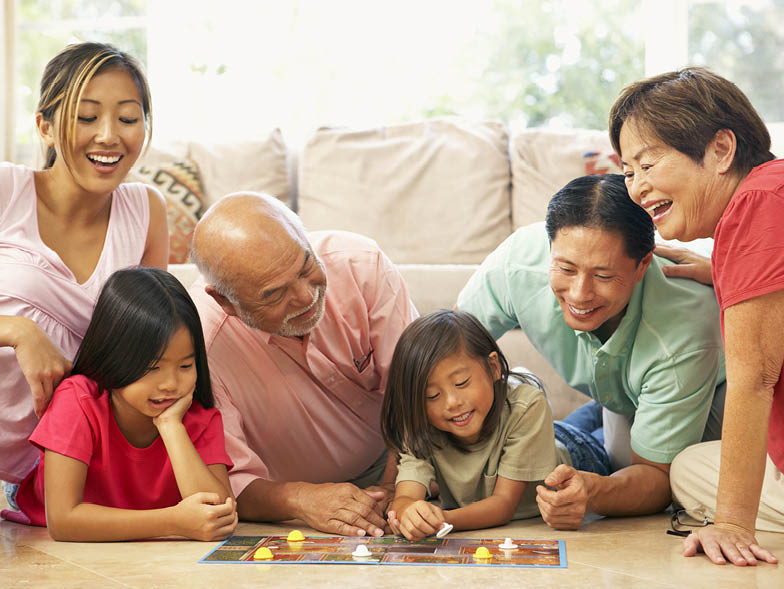Family playing boardgames on living room floor