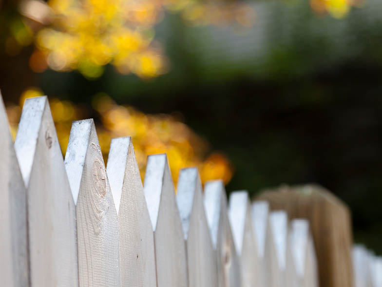 Closeup of white picket fence