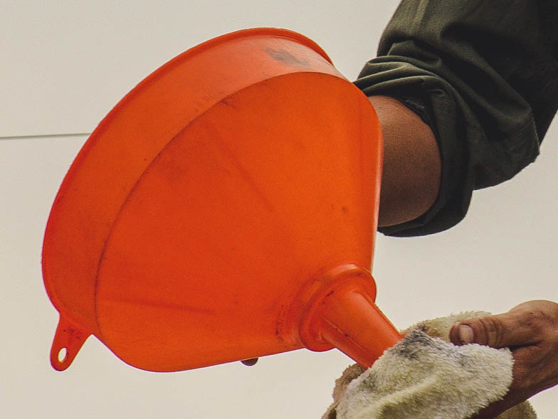 Person holding orange funnel