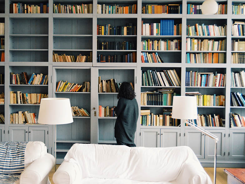 Woman standing in front of bookshelves