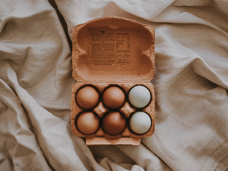crate of eggs on a blanket