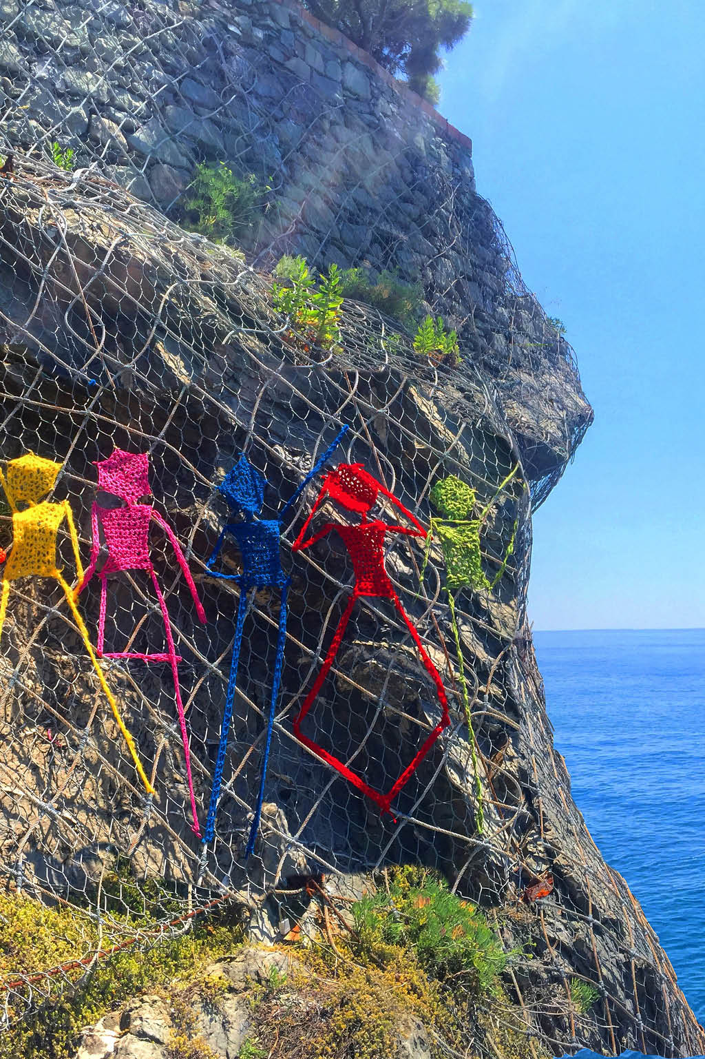 yarn people on the side of a mountain