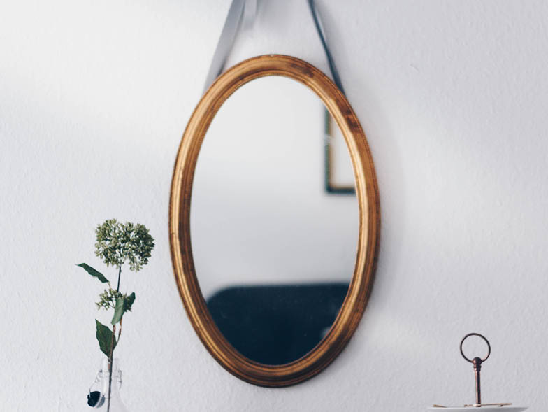 Mirror hanging on white wall