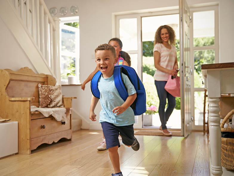 children running through the front door returning home from school