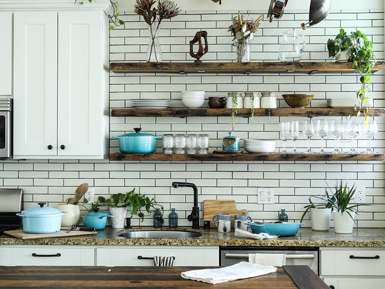 Organized kitchen with wooden shelves on wall