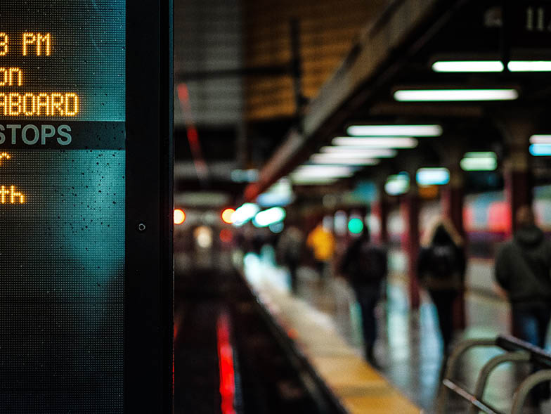 Subway platform featuring arrivals sign