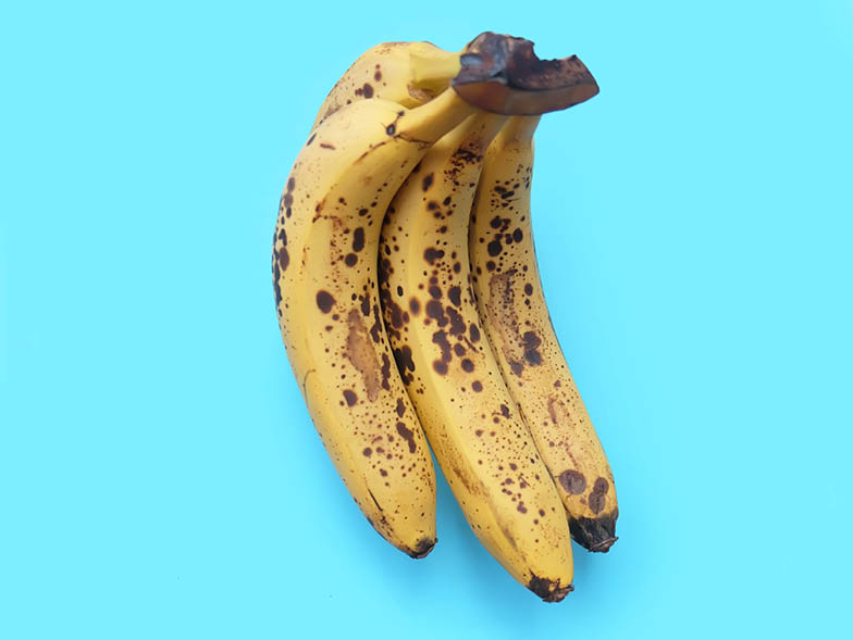 Ripe bananas on a blue background