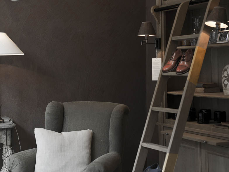 Home decor with pair of male's shoes on bookcase ladder