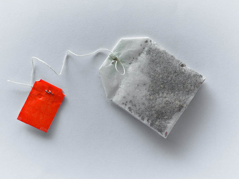 Teabag laying on gray surface
