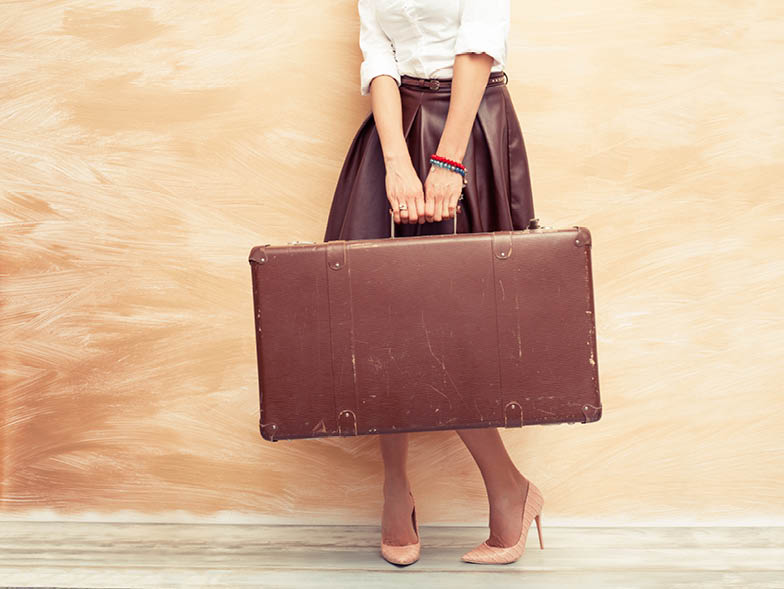 Woman holding vintage suitcase