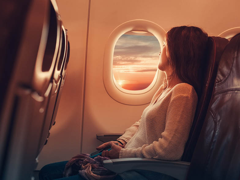 Woman looking out window on plane