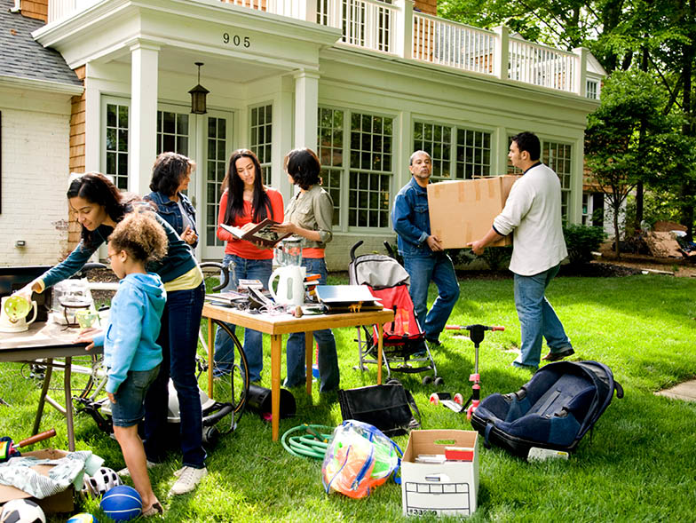 Multiple people interacting at a yardsale